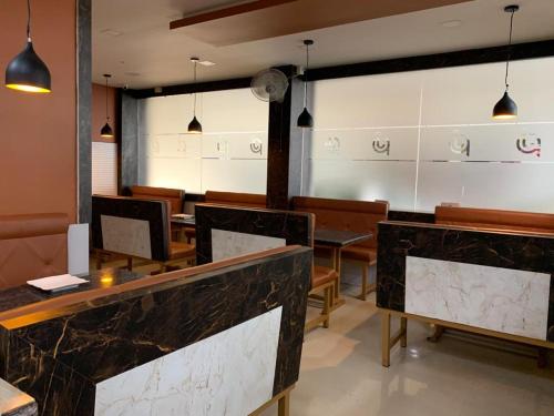 a restaurant with tables and chairs in a room at THE PORCH INN in Wayanad