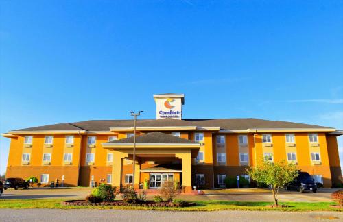 a large yellow hotel with a sign on top of it at Comfort Inn & Suites Greenville I-70 in Greenville