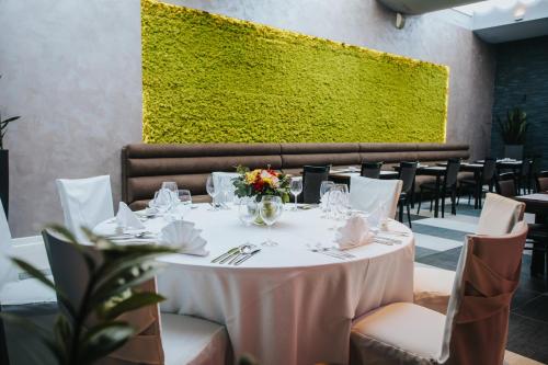 a dining room with a white table with flowers on it at Hotel Lero in Dubrovnik