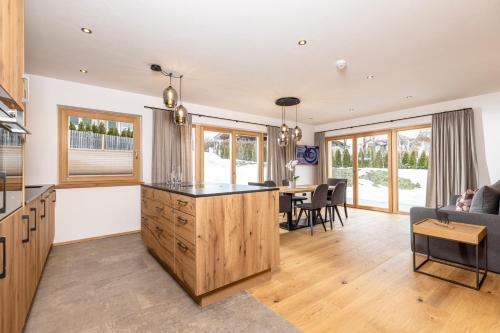 a living room with a kitchen and a dining room at Bichlhof Going in Going