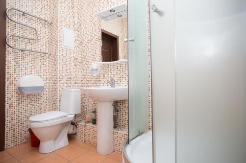 a bathroom with a toilet and a sink at Hotel Stara Zagora in Samara