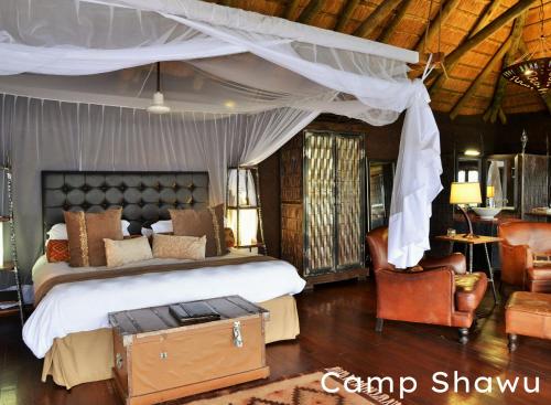 A bed or beds in a room at Shishangeni by BON Hotels, Kruger National Park
