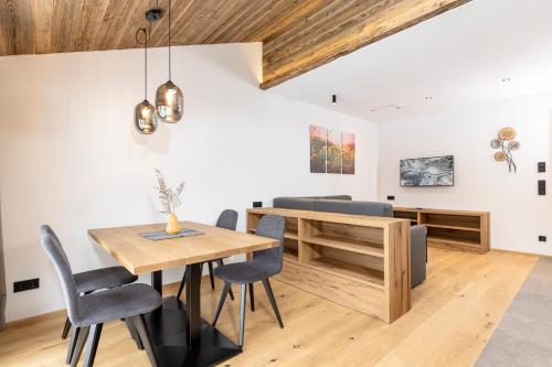 a dining room with a wooden table and chairs at Bichlhof Going in Going