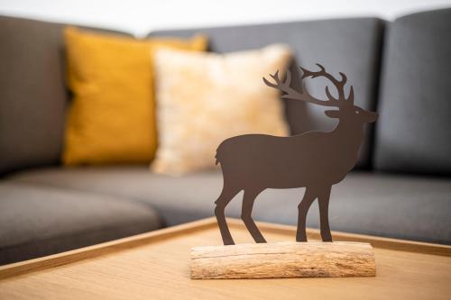 a small figurine of a deer on a table at Bichlhof Going in Going