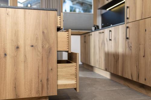 a row of wooden cabinets in a room with a tv at Bichlhof Going in Going