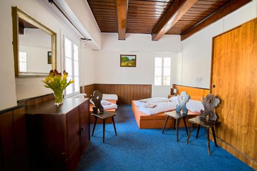 a living room with a bed and a couch at Penzion Na Rychtě in Malá Morávka