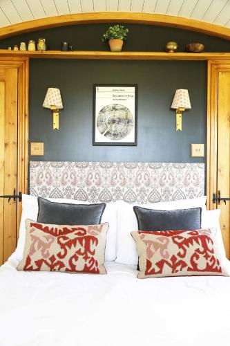 a bedroom with a white bed with two pillows at Westfield House Farm in Rothbury