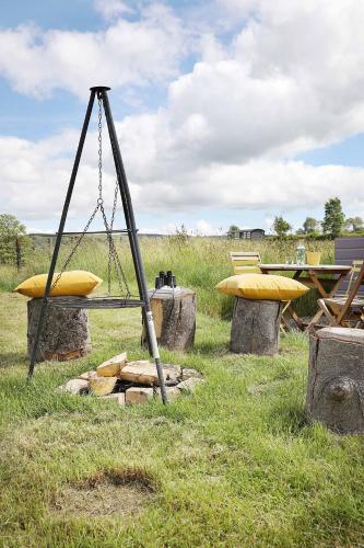 a swing and a picnic table in a field at Westfield House Farm in Rothbury