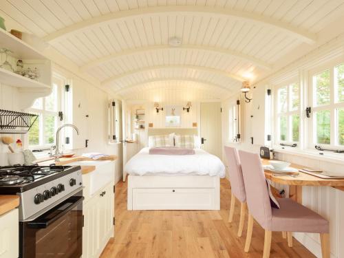 a kitchen with a bed in the middle of a room at Westfield House Farm in Rothbury