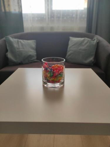 a glass filled with fruit on a white table at DC Ghencea 158 Self Check-in in Bucharest