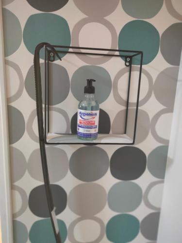 a bottle of cleaner sitting on a shelf in a bathroom at DC Ghencea 158 Self Check-in in Bucharest