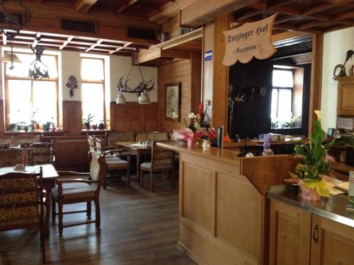 a restaurant with a bar and tables and chairs at Tutzinger Hof in Tutzing