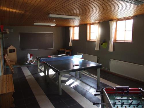 a room with a ping pong table and a screen at Skålleruds Gård in Åsensbruk