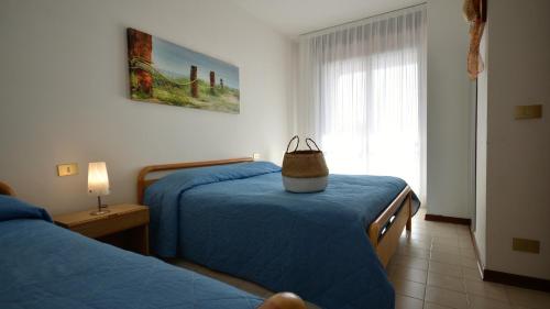 ビビオーネにあるAppartamenti Toninのベッドルーム1室(ベッド2台、上にバッグ付)