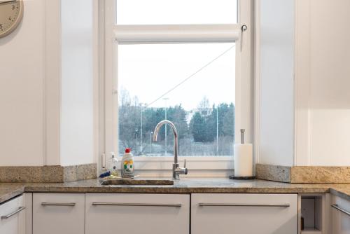 a kitchen with a sink and a window at Arthur's Seat View in Edinburgh