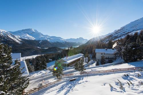 a view of a ski resort in the snow at Sternwarte by Randolins in St. Moritz