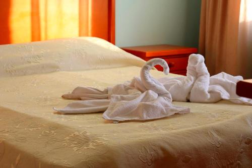 two swans made out of towels on a bed at Family Hotel LILI in Bansko