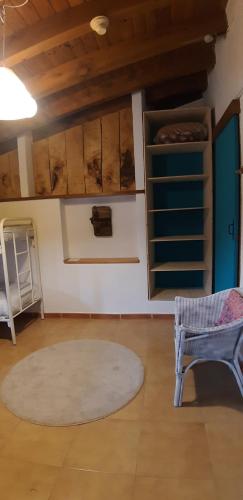 a room with a table and a chair and a rug at Alberg Rural La Rectoria de Pedra in Bellver de Cerdanya 