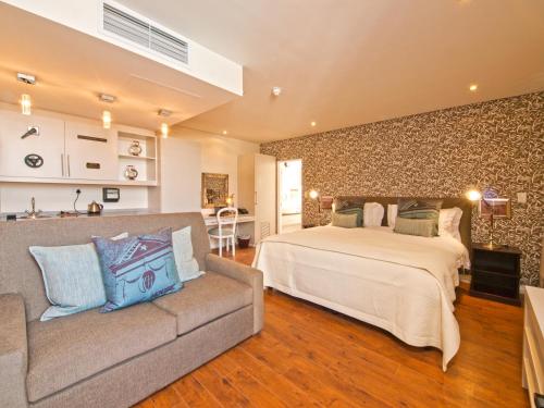 a bedroom with a bed and a couch at Turbine Hotel & Spa in Knysna