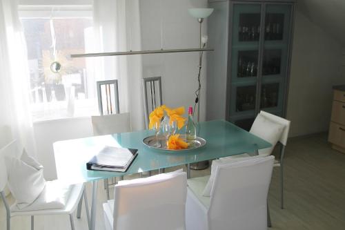 mesa de comedor con sillas blancas y azul en Haus Sonnenschein, en Lam