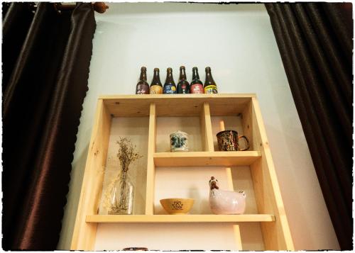 a shelf with bottles and other items on it at Nhà của Elly in Da Nang