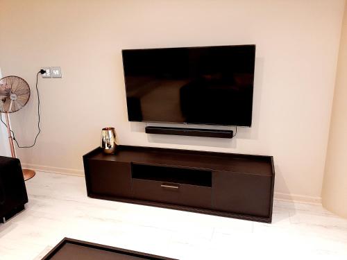 a living room with a flat screen tv on a wall at 4 on Pritchard Luxury Suites in Johannesburg