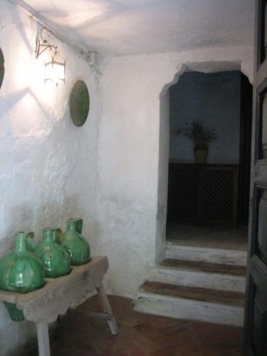 a room with green vases sitting on a table at Palacio de la Rambla in Úbeda