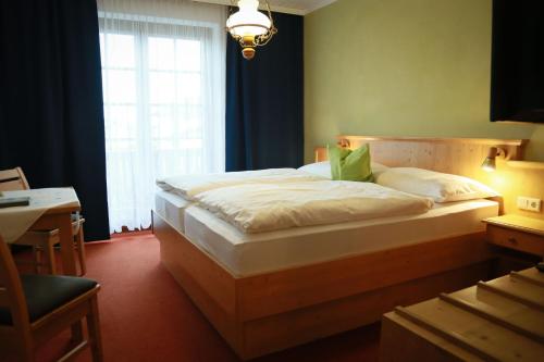 a bedroom with a large bed with a window at Haus Maria Holzöster in Franking