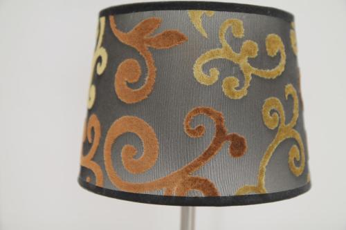 a table lamp with an orange and gray lamp shade at Haus Sonnenblick in Lam