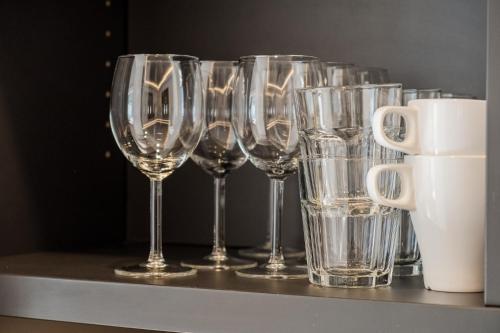 a row of wine glasses sitting on a shelf at Nena Apartments - Kreuzberg 61 in Berlin