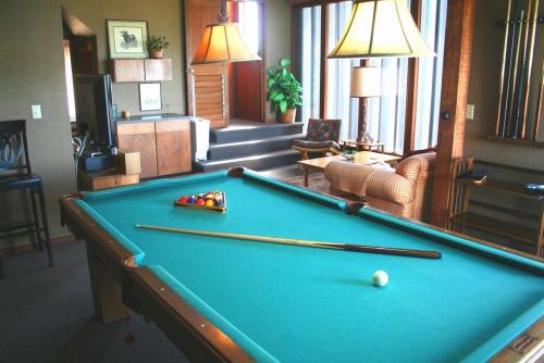 a pool table in a living room with afits at Abalone Alcove! Hot Tub! Pool Table! AMAZING VIEWS! Fast WiFi!! Dog Friendly! in Dillon Beach