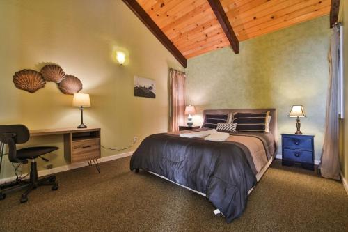 a bedroom with a bed and a desk with a computer at Beach Nest! Hot Tub! Sauna! BBQ Grill! AMAZING VIEWS!! Romantic Getaway! Dog Friendly!! in Dillon Beach