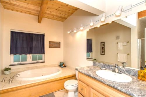 a bathroom with a tub and a sink and a toilet at Blue Cherry! Redwoods! BBQ Grill! Fire Table! Ping Pong! Fast WiFi!! Dog Friendly! in Guerneville