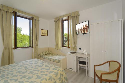 Postel nebo postele na pokoji v ubytování Hotel Vittoria