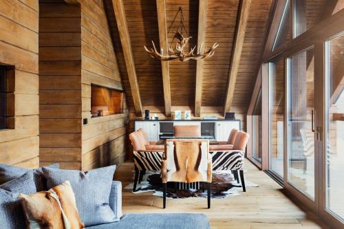 a living room filled with furniture and a fireplace at El Lodge, Ski & Spa in Sierra Nevada