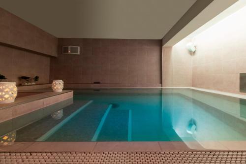 a large swimming pool in a room with a tub at Hotel Vista Mare & Spa in Cesenatico