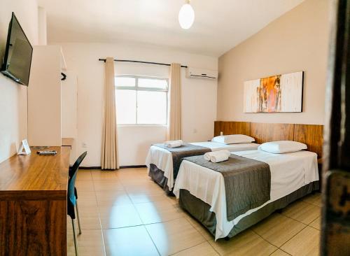 Postel nebo postele na pokoji v ubytování Cyrilo's Palace Hotel