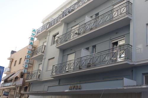 an apartment building with balconies on the side of it at Hotel Avra in Volos