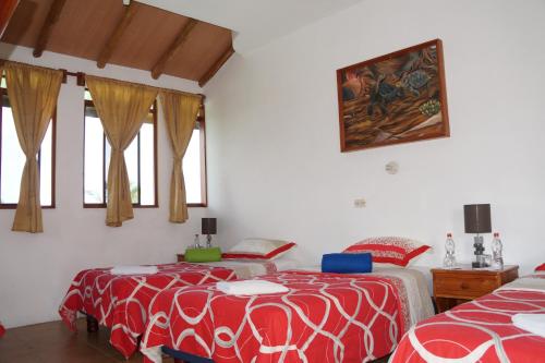 Cama o camas de una habitación en Galapagos Verde Azul