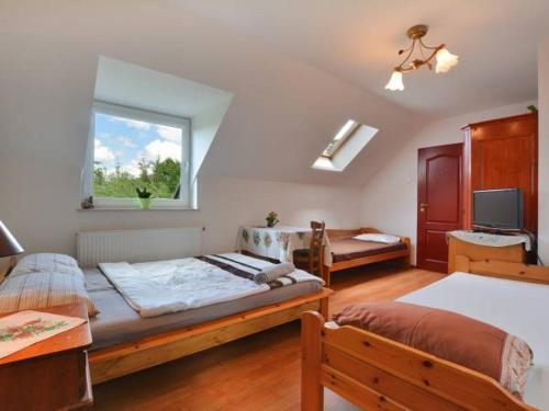 a bedroom with two beds and a window at Agroturystyka Nad Bugiem Szuminka in Szuminka
