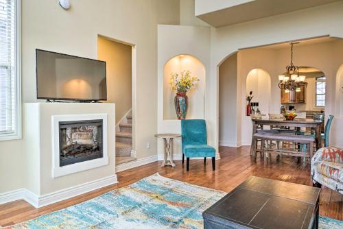 a living room with a fireplace and a dining room at Luxe Mtn-View Condo in Branson with Hot Tub Access! in Branson