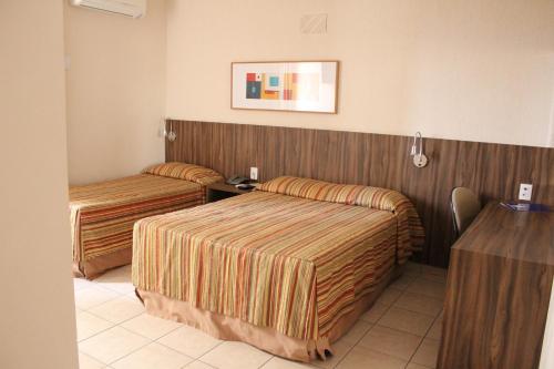 Cama o camas de una habitación en Hotel Riviera