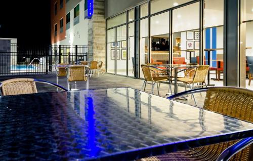 a table and chairs on a patio with tables and chairs at Holiday Inn Express & Suites Taylor by IHG in Taylor