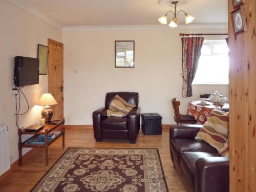 a living room with a couch and a chair at Mountain View Holiday Home by Trident Holiday Homes in Louisburgh