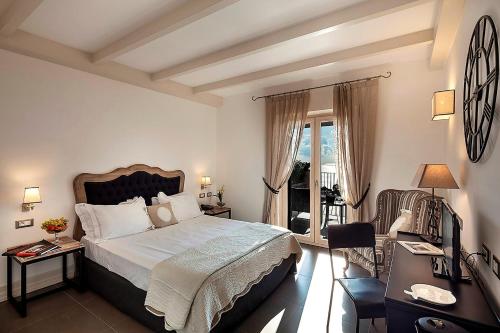 a bedroom with a large bed and a balcony at Tenuta Del Poggio Antico in Ischia