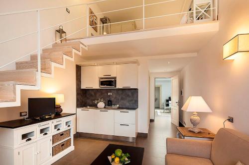 a living room with a staircase and a kitchen at Tenuta Del Poggio Antico in Ischia
