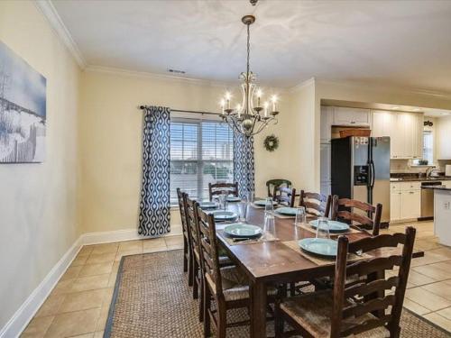 a dining room with a table and chairs and a kitchen at Ocean View Luxury Rental - Sleeps 16 in Myrtle Beach