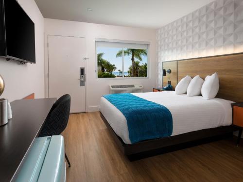 a hotel room with a bed and a desk at Motel 6-Santa Barbara, CA - Beach in Santa Barbara