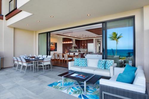 a living room with a white couch and a table at Timbers Kauai Ocean Club & Residences in Lihue