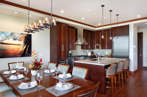 a kitchen and dining room with a table and chairs at Timbers Kauai Ocean Club & Residences in Lihue